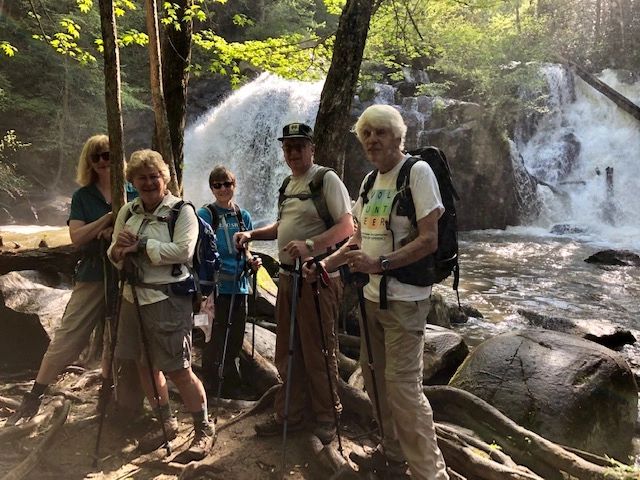 Hikers group waterfall forest trail