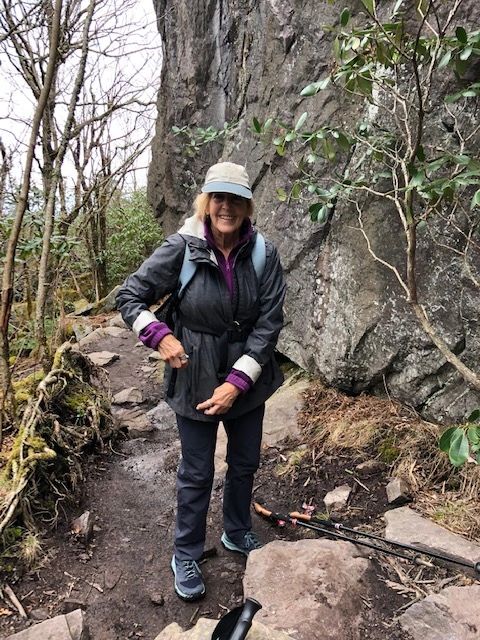 Woman hiker rocky trail boulder forest